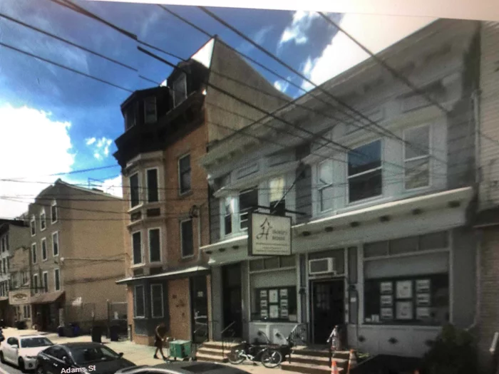 Investment opportunity with large commercial space and two 1 BR apartments. Good income with lots of upside potential. Large basement for storage. Washer dryer for tenants in basement.