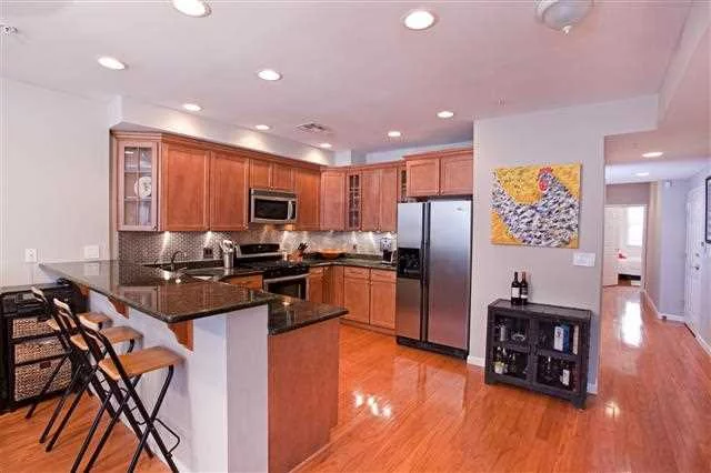 IDEAL LOCATION - steps to NYC Bus, PATH, & Washington St . Take the elevator up 1 flr to this home that features an open layout w/ great natural light. The open kitchen features granite counters, custom cabinets, SS appliances, bfast bar & dining table. The master bedroom features a full bath & walk-in closet, 2nd bedroom fits a queen bed, but would also make a great office/nursery. Enjoy the gas fireplace in the winter & the juliette balcony in the summer. Built in 2007, this is the 1st resale in the bldg.