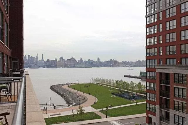 Live like royalty in exquisite 1971sqft 3BR+Large Den. Southern exposure will flood your new home w/light. Relax on your 36ft terrace while taking in views of Hudson River&NYC. Chef's kitchen features granite counters &ss appliances. Other features include HW floors, custom wall sconces & lots of closets. Community features 24 HrConcierge, 2Gyms, 2Pools, 2ComRms, landscaped rooftops garden w/BBQ's , fireplace & Outdoor TV. Commuter's Dream. Ferry couple of blocks away or private shuttle to path. Deeded parkin