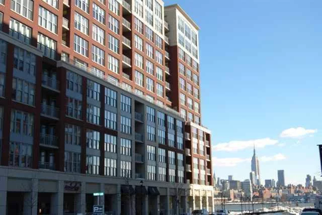 Maxwell Place, Hoboken's most sought-after community. Spectacular 1 Br + den has all the comforts you deserve. Elegant tiled-over foyer leads into expansive living/dining area, upgraded designer kitchen w/ ss appl, hw flrs, energy efficient HVAC & W/D, wet bar, everything appointed to finest detail. Great master suite that easily fits king size bed. Den has double French doors, can be used as baby's rm. Community room w/ direct NYC views, landscaped roof deck, 24 hr concierge, shuttle to PATH, prkg incl.