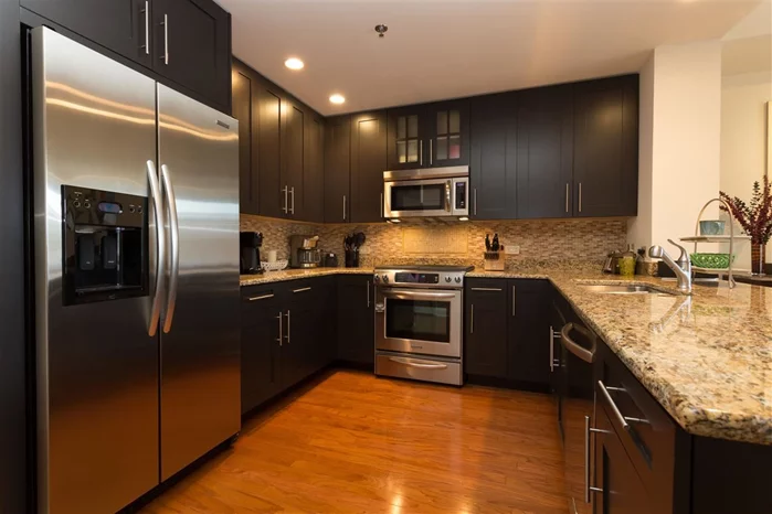 Live like royalty in Maxwell Place, Hoboken's most prestigious community. 1323 sqft, 1 Bedroom + Den (11'18 x 8'10) easily used as 2 BR. Chef's kitchen features granite counters, ss appliances, custom cabinets,  and custom backsplash. Oversized bedroom easily fits king bed. Concerned w closet space? Not in this home! Community features 24 Hr concierge, 2 Gyms, 2 Community rooms, 2 Pools, landscaped roof gardens w BBQ's, fireplace, and exquisite NYC views. Ferry around corner or take private shuttle to path