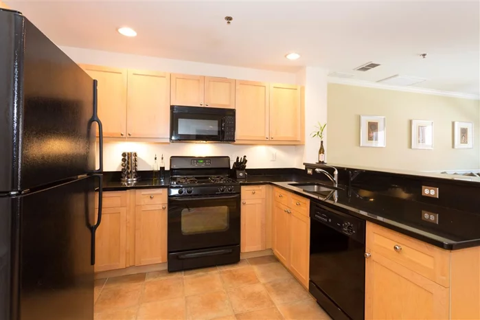 Welcome to the Huntington, this exquisite 1 BR+Den is easily used as a 2BR. Chef's kitchen features granite counters and custom cabinets. Other features include large master BR, walk-in closet, hardwood floors, and full size parking spot. Easy commute to NYC. Bus to NY around the corner or take the light-rail to the path.