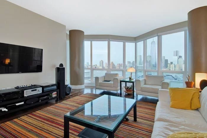 Gorgeous 2 bed 2 bath w/home office with panorama views of NYC in Jersey City's premier building 77 Hudson. 77 Hudson's curtain glass wall allows unobstructed views & extraordinary light w/ultra sleek European kitchen & baths. 44k SqFt of amenities incl. pool, hot tub, grill area, fire pit, gym, yoga, massage, steam rooms, sauna & more. Prime exchange place/Paulus Hook location offers quick commute to NY w/ferry, PATH & Lightrail @ your doorstep. 1 parking spot.