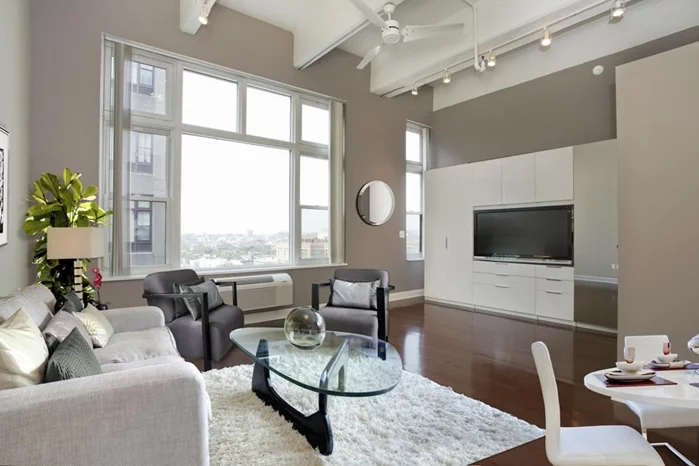 Meticulously maintained & extensively upgraded 735 SF alcove studio on the 10th floor of Hudson Tea. Open living space w/13'8 ceilings & oversize windows w/Southern exp. Upgrades include dark HW flrs, espresso kitchen cabs, quartz counters, SS apps, xtra storage cabinets, ceiling fan, track lights, white window frames, new doors/trim, new HVAC unit & new marble bath. Full service elevator bldg w/24hr concierge, gym, community & play rooms, shuttle to PATH & 1 blk to Ferry. Pkg avail for rent or purchase.