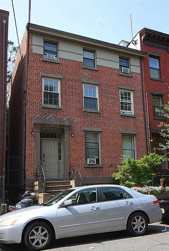 Historic row house near Van Vorst Park, this 1 bedroom/1 bath condo features: Exposed brick, lots of natural sunlight, granite counters/SS appliances, huge living/dining space, updated bathroom, newly laid hardwood floors, custom closets, washer/dryer & skylights,  huge deck and scenic position nestled amidst neighboring backyard and conveniently located 1.5 blocks to Grove St. PATH makes this a must see.