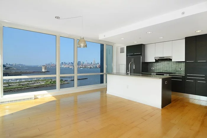 Crystal Point 2 bed 2.5 bath, 15Th floor waterfront luxury condo corner unit with breathtaking views of NYC and Hudson River from floor to ceiling windows. Unit boasts gourmet kitchen w/ Italian Pedini cabinets, quartzite countertop w/ metallic tiled backsplash, Jenn-Air appliances and a private balcony off the living room. Full amenity building, including pool, sauna, gym, game room and more. 1 car valet parking included. Steps to Path train, ferry and schools. Minutes to Manhattan.