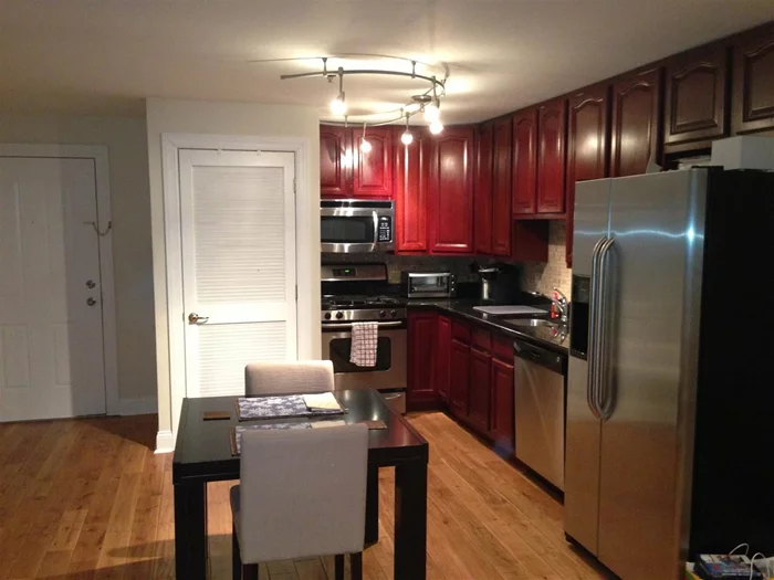 Exceptionally priced 1 bedroom condo with Deeded Parking just Minutes to NYC! Enjoy Manhattan Living Without Manhattan Prices! This Home features New wide plank Oak hardwood floors, Crown Molding, Cherrywood cabinets, granite counter top with recessed lighting and window shutters. Bathroom has travertine tiling, granite vanity & Jacuzzi tub. Central VAC & washer/dryer in unit makes an Excellent Value.... Bus to NYC outside your door, 5 minutes to Hoboken, NOT A SHORT SALE, make an offer!