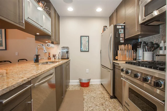 Impeccable 1Br/1Ba Condo with top of the line s/s appliances, granite counters, Mosaic bksplash, marble bath, W/D in unit, CA closets, oversized LR windows. Electronic curtains in living room & black-out curtain in Br. Smart Home Tech & Security pkg, 24 hr drmn, pool (next door bldg), jacuzzi, gym, yoga, billiards, theatre, play rm, storage for a fee, dog run & parking--garage or outdoor for a small fee/mo. 5 mins to Grove St Path, Ferry & Lt Rail.