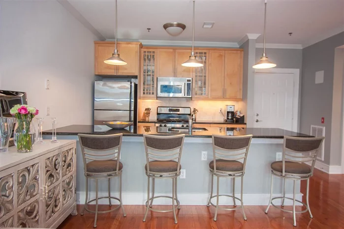 1BR/1BA at the Westfield, gorgeous sun-drenched unit on the top floor, with deeded garage pkg. Open kitchen with huge granite breakfast bar, 42 maple cabinets, SS appliances and tons of closet space. Large wall-to-wall WIC. HW floors, 9ft ceilings, large bath w/ marble vanity, 100 sqft balcony, C AC/H, W/D in unit & large windows. Common amenities includes gym & large common patio. Blocks to Lightrail, Shop Rite, Columbus Park & bus to NYC.