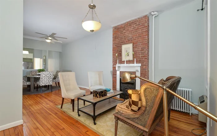 Bright, airy, and spacious two bedroom on uptown Hudson Street! Elegant old world details in this classic well proportioned home, like Golden hardwood floors, tin ceiling, large windows in every room, two interior transom windows, two nice size bedrooms, ornamental brick and iron fireplace, good closet space, high ceilings, and kitchen complete with stainless package: dishwasher refrigerator and microwave that vents to the outside, under cabinet lighting and wine rack. Near all Transportation and some of Hoboken's best stores and restaurants right outside and optional garage parking within a block or two, intercom system Laundry room and storage in the dry basement, heat and hot water included in maintenance.