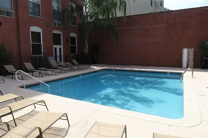 The pool is open! Tranquil oasis right in the midst of the city awaits you just in time for summer! Welcome to Downtown Hoboken's gated community, Grand Court, Penthouse Loft Unit 4F, with a huge private rooftop area with stellar NYC views perfect for entertaining & watching the fireworks! With a beautifully landscaped courtyard surrounding a shared in-ground pool, all in an elevator building & laundry on site, there's not much left to be desired. This spacious loft also features soaring ceilings, hardwood floors, a wood burning fireplace, dishwasher, stainless steel appliances, double vanity bathroom with jacuzzi tub and tons of storage. Minutes to walk to the PATH and parking nearby!