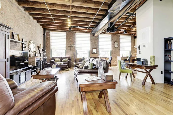 Welcome home. The living is easy in this impressive, generously spaced corner loft in the Hugo Pronti Artist building, a masterpiece of design and craftsmanship. Expansive living spaces graced by 13ft reclaimed wood ceilings, exposed brick walls, industrial age beams and steel supports, hardwood floors and a charming gas fireplace. Four massive 5' x 9' windows allow natural light to flow throughout the loft's open floor plan, which includes a bedroom, an office, living room and dining rooms and a large eat-in kitchen designed for entertaining. Additional features include: custom window treatments, towering kitchen cabinets, overhead artwork display lighting and your own exclusive outdoor terrace overlooking the Heights and offering views of the NYC skyline, including Freedom Tower. A deeded garage is included along with a large storage unit and shared laundry facilities on the ground floor. Here is an opportunity to own a one of a kind loft that will not last.