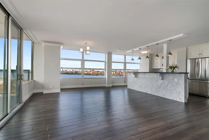 Stunning, 1450 sq ft, Totally Renovated, Spacious, very bright 2 bedroom, 2 bathroom corner unit with unobstructed NYC and Hudson River view in a luxurious 'Tower West building.Unit features all hardwood floors through out, Crown moldings with indirect led lighting and large terrace with W, N and E view.Renovated living & dining rooms, kitchen with custom made white cabinets, black Granite counter tops & white Quartzite back splash, all SS Appliances, SS farm Sink & designer pendant lighting . King size Master bedroom with brand new bathroom and separate double sink vanity and dressing area.Building has 24 hrs concierge service, Exercise room with sauna, Outdoor heated pool , Laundry Room and 1 car parking space.Bus to NYC, Ferry & Light Rail at door step. Close to all shops, Restaurants, parks, schools..Building has renovated in 2017.Monthly HOA $ 1096.42 , Capital expense $ 205.84, parking is $ 125. HOA covers heat, cold/hot water, gas, electric, all amenities in the building.