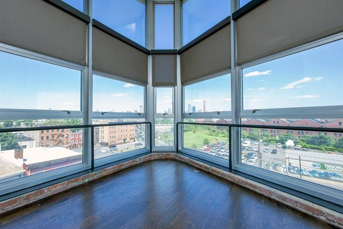 Welcome To Library Hall Lofts. This Historic Condo building is located in the budding Bergen Hill community of Jersey City. This SOHO style penthouse corner unit is spacious with soaring 15+ foot ceilings complimented by classic walnut hardwood floors. Floor to ceiling windows give way to picturesque-panoramic Manhattan views. Enjoy an abundance of natural light flow throughout the entire home. Well appointed kitchen featuring GE stainless steel appliances and sleek quartz counter tops. Convenient in-home amenities including Central A/C and Washer/Dryer. Enjoy breathtaking arial views of Manhattan and Jersey City from your common rooftop. Basement storage and 1 deeded garaged parking space included. Steps to Manhattan transportation.