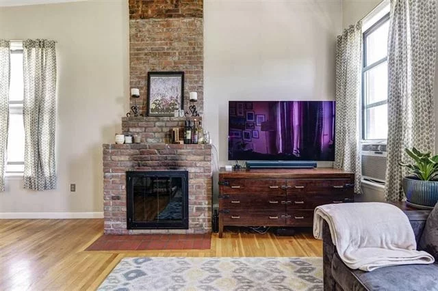 Walk home into this bright and beautiful 2bed condo in Historic Van Vorst Park neighborhood. This top floor corner Unit has it all: NYC views, wood burning fireplace with exposed brick, washer/dryer in unit, custom closets, ample closet space, and additional storage in basement. Shared roof deck with panoramic views, 14' ceilings, and beautiful hardwood floor complete the picture. Just steps to path, light rail, shops, restaurants and nightlife. Two flights up only.Low maintenance and taxes!Don't miss this one!