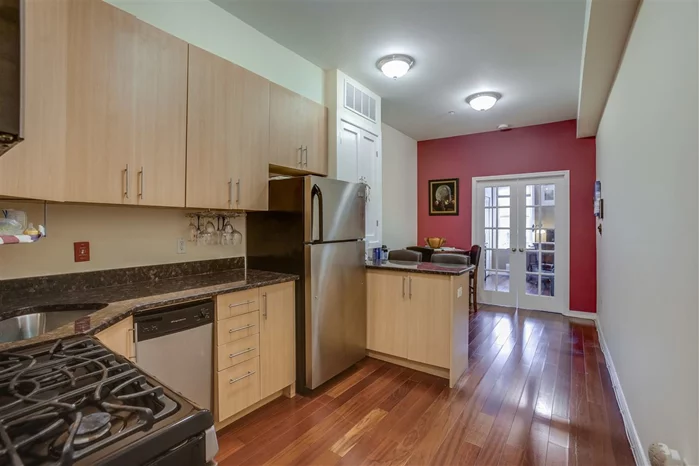 Fantastic 1 bedroom with 12 foot ceilings and the space you deserve. Kitchen features 42 custom cabinets, granite counters and stainless steel appliances. Bathroom has oversized shower with travertine tiles. Other features include hardwood floors, washer dryer in home, on demand hot water heater and storage in basement. Commuting is easy with bus to NYC around the corner.