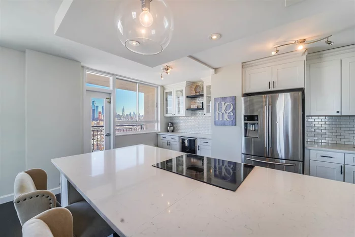 Don't miss out on this beautiful, sunlit 2 bedroom, 2 bath corner condo with private terrace in the coveted Doric. This spacious home has approx. 1, 100 sq. ft of living space with spectacular NYC & Hudson River views. The beautifully designed kitchen features custom white shaker cabinetry, SS appl, along with a built-in buffet and wine cooler. An oversized quartz island and large dining area give this home two large spaces for entertaining and work from home space. The well-laid out master bedroom has two double closets and a modern en-suite bathroom. Condo features wide plank hardwood floors and large sunlit windows throughout. The living room windows have north eastern exposure making it a beautiful view from any part of the room. This full-service luxury doorman building includes a laundry facility, grill/deli and valet dry cleaners. A fitness center, outdoor pool, and community room available for additional fees.  Located 1 block to Congress St. Light Rail Station with elevator access to Hoboken, NJ Transit Buses 123 & 119 to NYC. Free AM shuttle service to Hoboken PATH. NY Waterway Ferry, Shop-Rite, Trader Joes, Bow Tie Cinema, restaurants and shopping all nearby. JC Heights close with restaurants and farmer's market. Park and dog park located across the street from The Doric. This is easy living with a view that cannot be overlooked.  * Monthly maintenance fee of $1204.48 includes: Real Estate Taxes, Electric, AC, Heat, and Hot/Cold Water.