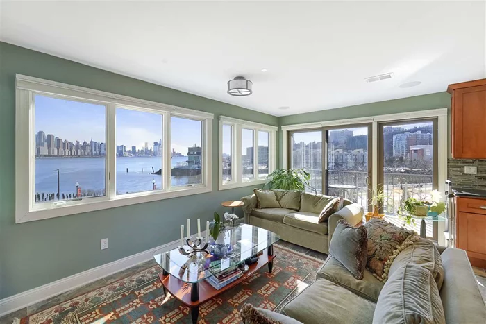 Located on the edge of the Hudson with Amazing DIRECT NYC and HUDSON RIVER VIEWS! Yes you can have it all! This 2546 SqFt 3 Br duplex was gut renovated in 2015 including electrical, and windows. Take the private elevator directly from your 2 car garage to either floor of your new home. Gourmet open style kitchen features stainless steel appliances including 48 4 burner, 2 oven plus griddle and grill stove, an abundance of custom cabinets, granite counters, island and custom backsplash. Just outside the kitchen is a large walk-in pantry. The rest of the main floor has a large dining and living room, wet bar with 2 large wine refrigerators and  bath. Relax on your 3 private balconies while watching the sun rise over or set against the Manhattan Skyline. Upstairs has 3 brs with the master br being 14 x 21 and has a giant walkin closet, en-suite bathroom with dual sinks plus separate shower and jacuzzi tub and skylight with Manhattan views and private balcony. Other great features include hardwood floors, custom millwork throughout, gas fireplace, built in Sonos and TV, on demand hot water heater , attic and of course those incredible NYC views. The association will begin an update of all exteriors in the complex in the Spring, with the landscaping to be completed after that. Commuters delight with easy access to the NYC Ferry, the Lincoln Tunnel and the GW Bridge. Finally the right place to call home! To view video tour copy link https://youtu.be/SCbsLXGA7lM