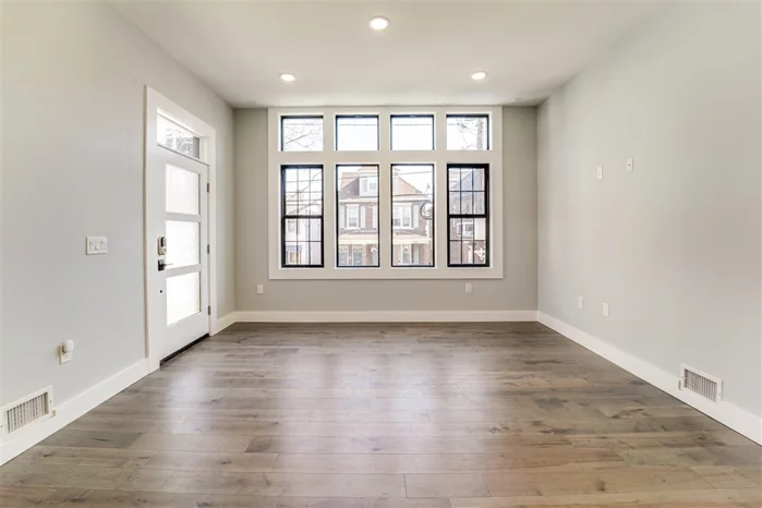 BRAND NEW HIGH-END NEW-CONSTRUCTION in the heart of Jersey City Heights. This amazing 3 Bedroom 2.5 Bath has 1400 square feet of open floor plan living space with soaring 10-foot ceilings, and oversized custom windows drenching the space in natural light. The renovated Chef's kitchen features shaker style white cabinetry, dark grey center island with Waterfall Quartz countertops, and the Stainless Steel Premium GE Cafe Package, complete with Smart Refrigerator and dishwasher. The large master bedroom has an en-suite bath, designer fixtures, and spacious walk-in closet. Also on the main floor are two more generous bedrooms with double closets, and a second full bathroom with quartz countertops and soaking tub. On the lower level, enjoy the family room with half bath, and sliding glass doors that lead to a private landscaped backyard and patio. This home has everything you need, including central air/heating system, hardwood floors throughout, 7-foot solid doors, in-unit laundry, plenty of storage and closets, AND 1 car Garage parking spot included. Close to 2nd St Light-Rail and minutes to PATH Train, this space is a commuters dream. Smart Home Technology with Nest thermostat and Smart Lock. Eligible for 5-year tax abatement! Come see the home today! Owner is a licensed realtor.