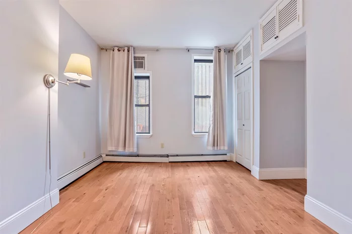 Amazing location in the height of Downtown Jersey City with very short walk to the Grove St Path!! Move right in to this well laid out parlor level 1 bed home (one flight up from outside) on a gorgeous tree lined street. Featuring beautiful exposed brick wall, marble fireplace, tall ceilings & hardwood floors throughout. This home has a nicely sized living room, eat-in kitchen & large bedroom located in the back for privacy. The kitchen includes SS appliances, granite counter tops and ample cabinet space. Other features include: wall AC in bedroom, W/D in unit, multiple closets in bedroom and a common yard! Close to transit, shopping, dining and entertainment. Easy commute to NYC. Low monthly HOA $185