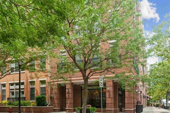 On a serene tree lined street in Paulus Hook (part of PS16 District), you will find a beautifully maintained courtyard facing 2 Bedroom, 2 Bath with a Sunroom/Den, Garage Parking in the Boutique Elevator & Amenity Building of Liberty View, Step into a gourmet kitchen with cherry cabinetry, SS appliances, white quartz countertops and a breakfast bar. Spacious master bedroom with double walk-in closets and master Bath with a separate shower, Jacuzzi & double vanity. An additional second bedroom with a walk-in-closet. Gleaming hardwood floors throughout, Central Air, side-by-side full-size vented washer/dryer in-unit, Upgrades include low volt high hats, designer light fixtures, and ceiling fans. Building amenities include: virtual doorman, package room, exercise room, bike storage, visitor parking and a courtyard with BBQ grills and outdoor seating. Conveniently located between the Grove/Exchange Path stations, Light rail and one block away from the Ferry. Across the street from Montessori School. Building lobby and hallway were recently updated, gym renovation planned for next year.