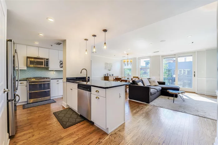 Expansive top floor 1733 SF, 3BD+Den, 2BA w/a balcony & deeded parking at The Oz, a steel & concrete, elevator building. One-of-a-kind 5th floor layout offers Western exp from every room & features a wide open KIT/LR/DR w/ gas FP & French doors to the balcony. Efficient floor plan provides 3 large BDRMs & an 8x10 den perfect as an office or guest room. Other highlights: central AC, crown molding, built-in audio, oak HW flrs, W/D & 1 car PKG. Building also comes complete with a fully equipped gym Located on Newark and Adams, you'll find easy access to shopping, dining, nightlife, NYC transit and so much more! Don't miss out on this truly exceptional home.