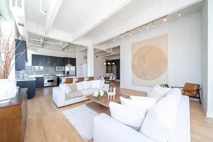 A rare opportunity to own this north/west facing true 3 bedroom corner loft in the coveted Harborside Lofts. Featuring NYC and cove/river views, this is the first in this line/layout to hit the MLS above the ground floor in 11 years! This loft's 7(!) oversized windows allows for an abundance of natural light.The open floor plan and tall 13ft ceilings makes this home feel even more spacious than its already generous sf. The loft features a very large living, separate dining area and a suburban sized kitchen with an oversized kitchen island. The gourmet kitchen comes with all high end appliances incl. 6 burner Viking stove, Sharpe microwave drawer, Miele hood, Bosch dishwasher and Miele refrigerator. There are hardwood floors throughout, tons of storage (incl. coat closet, linen closet and a large walk-in in master bedroom) Custom automated window treatments and custom closets throughout. Maint fee includes gas and hot water. One car garage parking included in the sale. Building and association amenities include common rooftop terrace with outdoor kitchens, 24 hr concierge, shuttle to path, 3 gyms, children's playroom, residence lounge and pool.