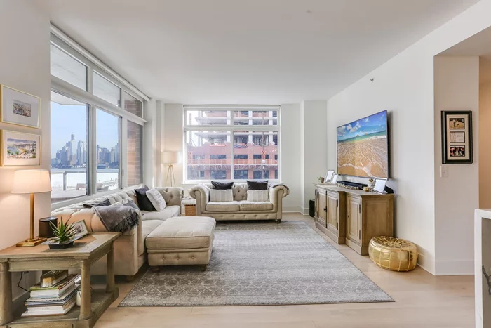 Located in one of Hoboken's most sought out luxury buildings- Toll Brother's 1400 Hudson! This Exquisite 1300 SQFT 2 Bedroom/ 2 Bathroom condo not only has the space and comfort you deserve but also has fantastic NYC views that include Hudson Yards. Open style gourmet kitchen features Quartz counters, island, Thermador and Bosch stainless steel appliances and custom gray cabinets. Other features include hardwood floors throughout, all closets are outfitted with custom closet organizers, remote window treatments in all rooms, PLUS bedrooms are equipped with blackout and regular shades. Are you an outdoor lover? If so, please imagine yourself relaxing on your own, large and private balcony that also looks directly over to NYC. 1400 Hudson features top of the line amenities which include 24-hour Concierge, a Resident's Lounge with wide screen TVs, Rooftop Pool with Skyline views, Deck with Fireplace and BBQ grills, Fitness Center, Yoga Room, a Game Room and Children's Playroom. A Commuter's dream with the ferry and bus to NYC around the corner or take the private shuttle to the path. Indoor parking in the building included!