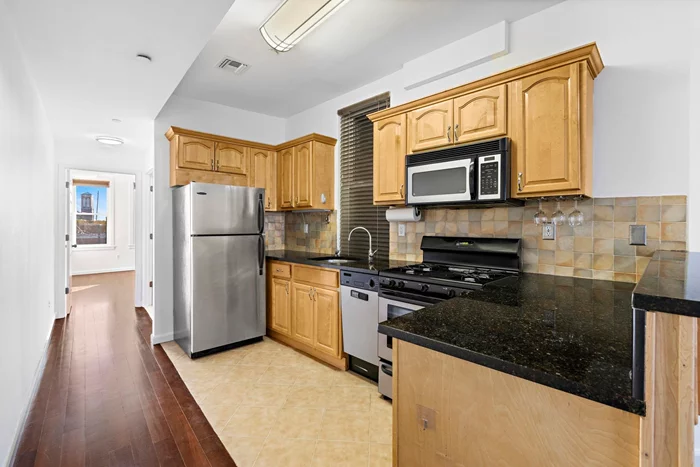 Super Ball OPEN HOUSE : February 11, Sunday at 1-3pm!!! Welcome to the vibrant downtown neighborhood of Jersey City Village! This turnkey ready home, spanning 863 sq ft open layout kitchen with granite counter tops, and a breakfast bar that opens up to the living area, it's the perfect setup for entertaining guests. The home also includes a tastefully designed en-suite master bathroom with a stall shower and a second full bathroom featuring a pedestal sink and a tub. The beautiful hardwood floors and decorative fireplace mantel add a touch of elegance and warmth to the space. Additional features include central air, free on-site laundry facilities, and a large deeded storage unit in the basement. This prime location offers close proximity to JC's Grove Street PATH station, trendy restaurants and shops,  parks, and the train into Manhattan.