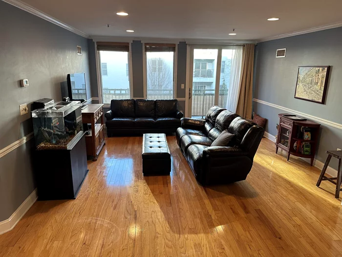 Spacious 2Bd/2Bth in sought-after elevator building, the Oz. 1204 sq feet. 1 covered deeded parking space. Balcony. Hardwood floors. W/D in unit. Central air/heat. Walk to PATH train and ferries to Manhattan and Hoboken shops and restaurants. Master bedroom12x21, Second bedroom 11x12'9, Living room 15x21