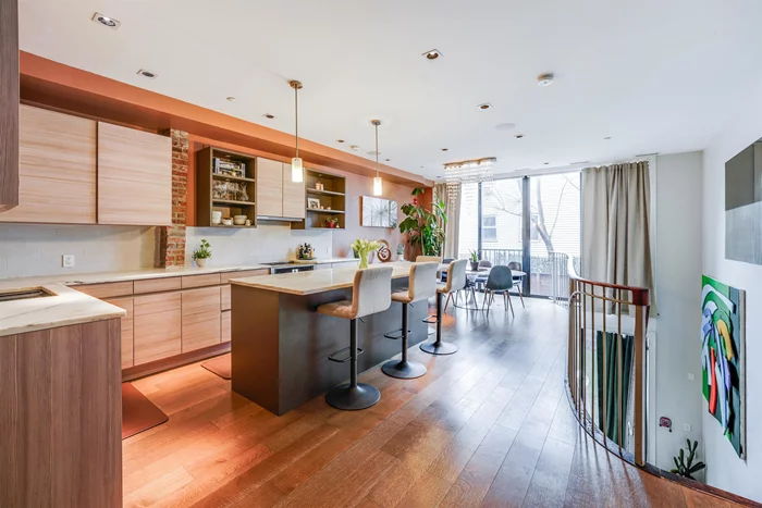Welcome to this exquisite 3-bedroom, 2.5-bathroom duplex condo with deeded parking in the heart of Paulus Hook, offering a perfect blend of urban living and contemporary comfort. Originally built in 1840, this remarkable property underwent gut renovation during 2016-2017, resulting in a harmonious fusion of old-world charm and modern luxury, with an original facade and front steps. Spanning approximately 1, 780 square feet, the condo boasts a serene 500-square-foot private landscaped backyard with a summer kitchen, and a welcoming 400-square-foot front area with parking, enveloping residents in a haven of tranquility. Step inside to discover a realm of digital sophistication. Lighting and shades are effortlessly controlled offering unparalleled convenience and ambiance customization. Meanwhile, the built-in speakers in the dining, living rooms, and backyard, create an immersive audio experience. The culinary epicenter of this home is a meticulously crafted kitchen, boasting a Germany-made kitchen, alongside American-made appliances. Marble countertops elevate the space, while custom floor-to-ceiling windows flood the area with natural light, beckoning culinary adventures. Retreat to the master bathroom, a sanctuary of opulence epitomizing both style and functionality. Meanwhile, the living room beckons with panoramic views through custom floor-to-ceiling windows and sliding doors that open up and connect with the private backyard. This meticulously curated home blends historic charm, modern convenience, and timeless luxury, offering an unparalleled lifestyle experience in the heart of Jersey City's Paulus Hook.