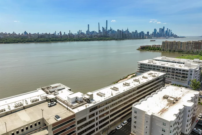 Unmatched views await you in this luxurious penthouse featuring 2 bedrooms and 2 baths. Step onto the outdoor balcony for direct views of the Hudson River and NYC skyline through the expansive floor-to-ceiling windows. The unit boasts high-end finishes such as hardwood flooring, 10-foot ceilings, and a deluxe bathroom with a large stall shower and soaking tub. The spacious kitchen is outfitted with a sizable island, Caesarstone countertops, and Bosch appliances. Convenience is at your fingertips with in-unit laundry and two parking spaces available for a fee. Enjoy The Pearl's amenities including a fitness center, outdoor pool, rooftop deck, and residents' lounge. Steps away, find elegant restaurants, shops, and riverside parks, enhancing your living experience. 2 Parking spaces included for a monthly fee
