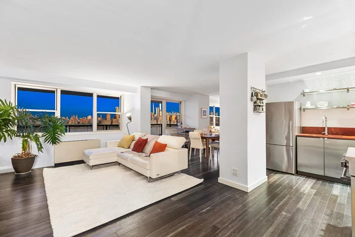 This stylish, fully updated apartment - originally a two bedroom - has been opened up for maximum functionality combined with stunning NYC views. As you enter the main living area in this preferred D-Line corner unit, you will find yourself mesmerized by the sweeping views of the NYC skyline and the Hudson River. The open kitchen features granite countertops and high-end stainless-steel appliances. Off the living room there's a very large office/guest area  which was originally the 2nd bedroom (easy to convert back). Throughout the unit you'll find upgraded bamboo floors and designer finishes. Both bathrooms have been entirely updated. Completing the unit are an abundant amount of system-fitted closets, a long functional hallway that doubles as your own library and art gallery, and a generous, city-facing terrace. The Versailles is a full-service building offering 24/7 concierge service, gym, kickboxing studio and a spectacular outdoor pool and patio with skyline views. All utilities, taxes and concierge services included in the monthly maintenance fee. Bus transportation to NYC or Shuttle to Ferry/Light Rail are right in front of the building. Enjoy living in vibrant West New York with many shops, cafes and restaurants and parks nearby.