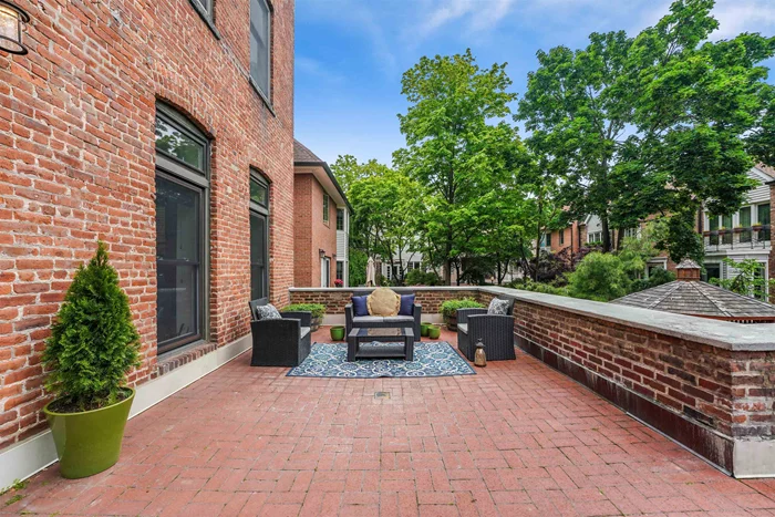 This newly renovated 2-bedroom/2-bathroom with parking and a large outdoor terrace home has it all! Originally a brick factory built in 1901, the complex features a fully landscaped interior courtyard enjoyed from your oversized patio at your private entrance. The living area boasts a loft-like feeling with brick walls and is perfect for entertaining with a large living and dedicated dining space. The primary bedroom has a newly updated bathroom and a separate work-from-home space. A second bedroom and bath provide flexibility for family, guests or office/gym. The home boasts new floors, plenty of storage, and granite countertops. Roberts Court is a gated community with lovely common gardens, a fitness center, and guest parking. Located within blocks of buses to both Port Authority and Hoboken Terminal, an easy walk to the NY Waterway Ferry, PATH, Light Rail, Washington Street, and the Hudson River Waterfront. Hoboken has an extensive array of schools, shopping, dining, coffee shops, and farmers' markets. Located next to Columbus Park with its tennis and basketball courts, playgrounds, Hoboken's newest Resiliency Park.