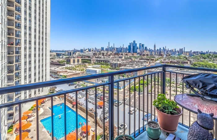 FIRST OPEN HOUSE, SUNDAY JUNE 16TH, 12-2PM. Largest 2-bed, 2-bath floor plan with an extra bonus room! Incredible NYC views with a private balcony. Move-in-ready and Renovated (1140 S.F.) The Kitchen, Center-island Breakfast Bar anchors the room with continuous granite countertop and custom cabinetry. The kitchen has top-of-the-line appliances, Samsung-4-door stainless refrigerator, KitchenAid glass top range and Bosch dishwasher. New flooring in soft grey, Soffit spot lighting and crown molding throughout. Plenty of storage with 7-ceiling height, large custom closets, pantry and double closets. Primary bedroom captures with striking views of NYC, easily fits a King bedroom set, the ensuite bathroom is pristine with decorative ceramic tile, spa shower and modern fixtures. The second bedroom has views of upper Manhattan and fits a queen suite. Guest bathroom has a deep bathtub/ shower with sliding framed glass doors. The bonus den is off the main room, great for an office or home gym. Formal or casual dining, there's room to host all your guests with impressive views of the City. The building is staffed 24/7, concierge/doorman, live-in super, dedicated package receiving and property management office. Amenities include seasonal heated pool, sundeck, courtyard, co-share work room, resident's lounge, table tennis room, rental parking, EV charging stations, gym, grill-deli, storage, dry cleaner, laundry and on-premise Daycare. Located between Hoboken/ Jersey City Heights. Washington Park is just across the street with 22 acres of multiple sport courts, special events and a substantial new dog run. Commuters choose from express buses, front door to NYC in 15 minutes, Light Rail Train or Free AM shuttle to the Hoboken PATH. Trader Joe's, ShopRite and all of Hoboken is an elevator ride away. This large East facing home has one of the lowest monthly costs per S.F. at the building. Monthly fees include Taxes and Utilities (electric/AC/heat/hot/cold water are included) Some amenities have a nominal fee. Current assessment starts July for 12 months. OPEN HOUSE SUNDAY.