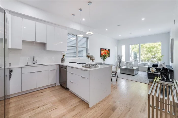 Introducing this exquisite BRAND NEW Construction residence at 63 Stegman St, a 2 bedroom plus den Duplex with fenced-in Private Backyard & option for garage parking! Build with superior quality, this home features oak flooring throughout, 10 ft ceilings, surround sound & an open concept kitchen/living space with high-end Pella windows.  Enjoy your large (12x15) master bedroom with double closets, bonus terrace & en-suite bathroom with rain fall shower, double vanity sinks filled with porcelain tile. Only a quick 10 min walk to NYC Lightrail, enjoy this high-end quality build including 10 YEAR HOME BUILDERS WARRANTY AND A GENEROUS 5 YEAR TAX ABATEMENT. Come see this amazing home today before it's too late!