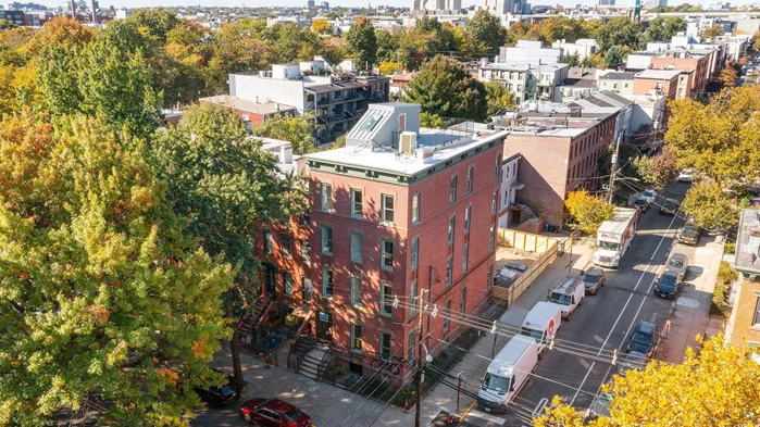 Discover luxury living in this newly constructed, four-bedroom, two-and-a-half bath duplex condominium at 647 Jersey Avenue. This remarkable residence spans the top two floors of a historic corner building in Downtown Jersey City's mostcoveted neighborhood, featuring an ideal blend of historic charm, modern craftsmanship, and high-end finishes. Step inside to find a spacious, light-filled home with three exposures and meticulous design throughout. The upper floor showcases exposed brick walls that perfectly complement a striking architectural steel staircase, leading to a private rooftop deck with views of Hamilton Park and the NYC skyline. The custom-designed gourmet kitchen is a chef's dream, equipped with premium JennAir appliances, a professional 6-burner gas range, Sharp microwave drawer, JennAir range hood, and an undercounter wine and beverage refrigerator. The centerpiece, a stunning 10-foot island with Florence Gold quartz marble countertops and backsplash, sets the stage for both intimate meals and memorable gatherings. Retreat to the primary suite featuring a walk-in closet and a luxurious en-suite bathroom with a dual gray vanity, quartz countertops, custom oak cabinetry, and an oversized glass-enclosed shower. The secondary bathroom offers a stylish soaking tub, and top-quality finishes, including large-format porcelain tiles and Kohler fixtures. Every aspect of this home is designed with comfort and convenience in mind, from state-of-the-art HVAC and smart home technology to avideo intercom system, robust network infrastructure, and cloud-accessible building surveillance. Customizable LED lighting and a deeded storage room in basement provide additional luxury and functionality. In addition to the private laundry rooms in each unit there is a full-size washer/dryer in the basement for use by both unit owners. Located steps from the vibrant Hamilton Park and within walking distance of the Grove Street PATH Station and Hudson-Bergen Light Rail, this home offers unmatched access to NYC and all of Jersey City's boutique shopping and dining options. Embrace the ultimate townhouse-style living with space, style, and convenience at the center of one of Jersey City's most sought after areas.