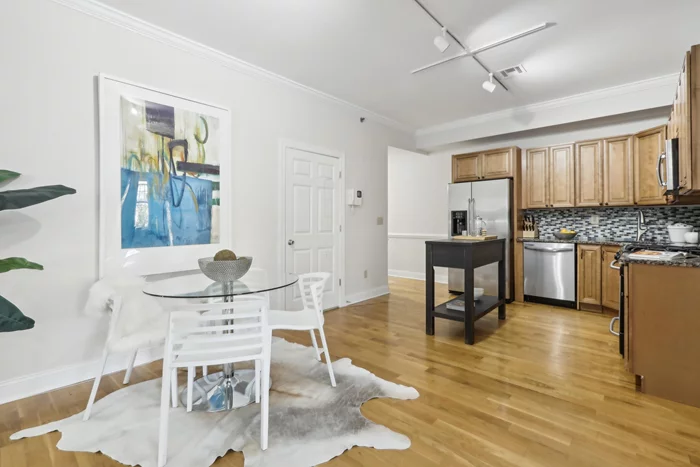 Located just minutes from the Journal Square PATH station, this well-maintained 2-bedroom condo with parking offers convenience and comfort in one of Jersey City's most vibrant and connected neighborhoods. The spacious bedrooms feature large windows that flood the space with natural light, and both include ample closet space to meet all your storage needs. An open-concept kitchen, dining, and living area creates a welcoming flow that's perfect for everyday living and entertaining. The kitchen is outfitted with maple cabinets, granite countertops, and stainless-steel appliances, including a brand-new dishwasher, offering a stylish and functional space for any home chef. Hardwood floors throughout the condo add warmth and character, while the entry foyer offers an ideal nook for a home office or additional storage. This unit boasts recent upgrades for modern comfort, including a boiler that's less than a year old and central air installed within the past two years. The building provides residents with a convenient laundry room and private storage lockers. A basement parking garage with remote control entry adds an extra layer of convenience, and the condo comes with one dedicated parking spacean invaluable feature in Journal Square. Enjoy the energy of Journal Square, where dining, shopping, and entertainment options abound, all while being a quick commute from Manhattan. Whether you're a first-time buyer, a commuter, or simply looking for the perfect Jersey City home, this condo has everything you need to live comfortably and stylishly in a prime location!