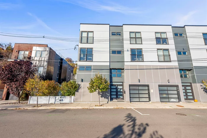 1 block away from the bus stop and 7 minute bus ride to New York City Port Authority bus terminal. The bus arrives every minute during rush hour!! This is the sun-drenched and luxurious townhouse you have been waiting for. A must see!  This modern designer 3-floor 3 bedroom 3.5 bath smart home was built in 2020, everything was meticulously kept and in almost new condition, is an architect's masterpiece. The house boasts 3 private entrances, an open floor plan, high end finishes, soaring windows, a floating staircase, double vaulted ceilings, hardwood floors, custom cabinetry, designer kitchen, 2 sided fireplace and a gorgeous primary bedroom w/ a luxurious en-suite bathroom w/ extra large steam shower, electric window treatment. Entertain family and friends on your rooftop with show-stopping views, and enjoy the ease of your own garage, additional parking on site and in-unit washer and dryer. Within a few blocks you'll benefit from the fastest & most convenient access to NYC: Light Rail, Bus, Ferry all within easy reach.