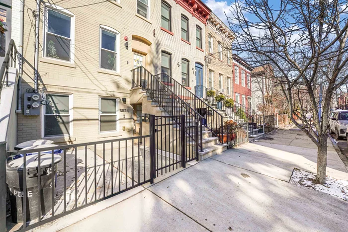 OPEN HOUSE - SATURDAY 12PM - 2PM!! Steps from Liberty State Park and the Light Rail! Welcome home to this fully renovated duplex boasting pride of ownership throughout. This 3 bedroom 1.5 bathroom offers an unbeatable location, modern design, and a private backyard oasis. The classic but modern brownstone exterior has the ultimate curb speak inviting you in.  The space has large windows, hardwood floors, and a neutral palette just fully re-painted in Benjamin Moore's Swiss coffee color.  The kitchen boasts dark cherry cabinets, white quartz countertops, a tile backsplash, newer stainless steel appliances, and durable tile floors. Bathrooms is hotel-inspired and accessible via the primary bedroom or hallway, featuring black porcelain counters, full-height slab tile, rainfall showerhead, and spacious vanities. The rearmost bedroom has sliding doors to the landscaped backyard with a fire pit, paver patio, and lawn area, perfect for relaxing or entertaining and a huge value add here in the city. Additional amenities include a full-sized washer/dryer, Minisplit heating and cooling and easy access to downtown Jersey City. This home seamlessly blends location, luxury, and lifestyle in one of the area's most sought-after neighborhoods. Call now for more information or to schedule a private tour!