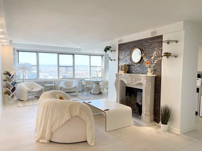 Discover your urban oasis at 225 Saint Pauls Ave, Journal Square - a meticulously renovated 1, 025 sq. ft. penthouse unit (17D) featuring beautiful open windows with magnificent views, including some NYC vistas. This sun-drenched NW corner residence boasts an array of luxury upgrades from two years ago, including updated tile floors throughout, freshly painted interiors, a completely renovated kitchen with modern appliances and cabinetry, an elegant marble accent wall in the living room, electric fireplace with stone surround and Japanese tile, updated bathroom with new vanity and fixtures, and a built-in closet with French doors. Enjoy the convenience of a 96% walkable neighborhood, just 4 blocks from the Journal Square PATH station and a mere 20-minute commute to NYC. This premier building offers a host of amenities, including 24-hour concierge, secure package delivery, fitness center, laundry facilities, outdoor pool, park area, children's play area, and gated parking for only $100/month. Maintenance fees of $999 include heat, hot water, AC, and gas. This turn-key ready home comes fully furnished, with all furniture and decor included in the sale price, offering exceptional value. Schedule your private showing today and seize this opportunity to own in Jersey City.