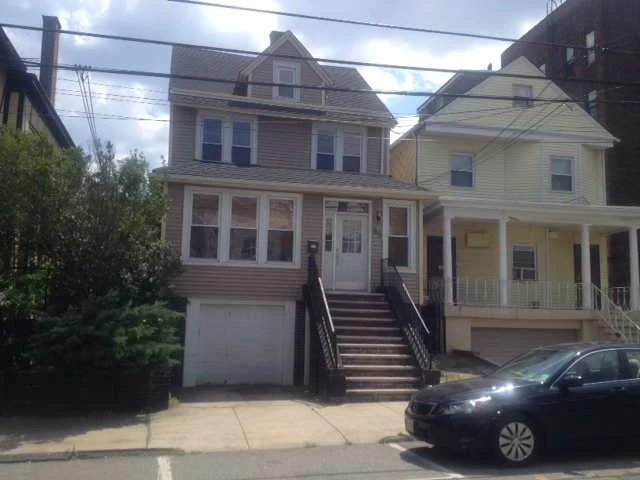 2 Family House, Recently used as one family features 4/4 rooms on each floor, w/2 BR on each. New upgrades include vinyl siding, windows, front door garage, baths, & freshly painted, & laminated wood floors. Large basement with 2 storage rooms, & laundry. Very large backyard. Great location one block to Blvd East w/all trans to NYC & less than 1/2 block Park Ave stores