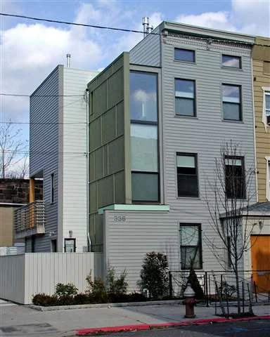 This downtown two family rowhouse has vinyl siding on facade, clerestory windows and cornice but within a contemporary framework. The two separate living spaces are connected on the inside with a double-sided security door which allows flexibility for use as either a one or two family. Duplex is flooded with light.kitchen opens onto a 200 sq ft. deck. 1 bedroom garden unit has original pine floors, and exposed brick. kitchen door opens onto private patio and garden area.