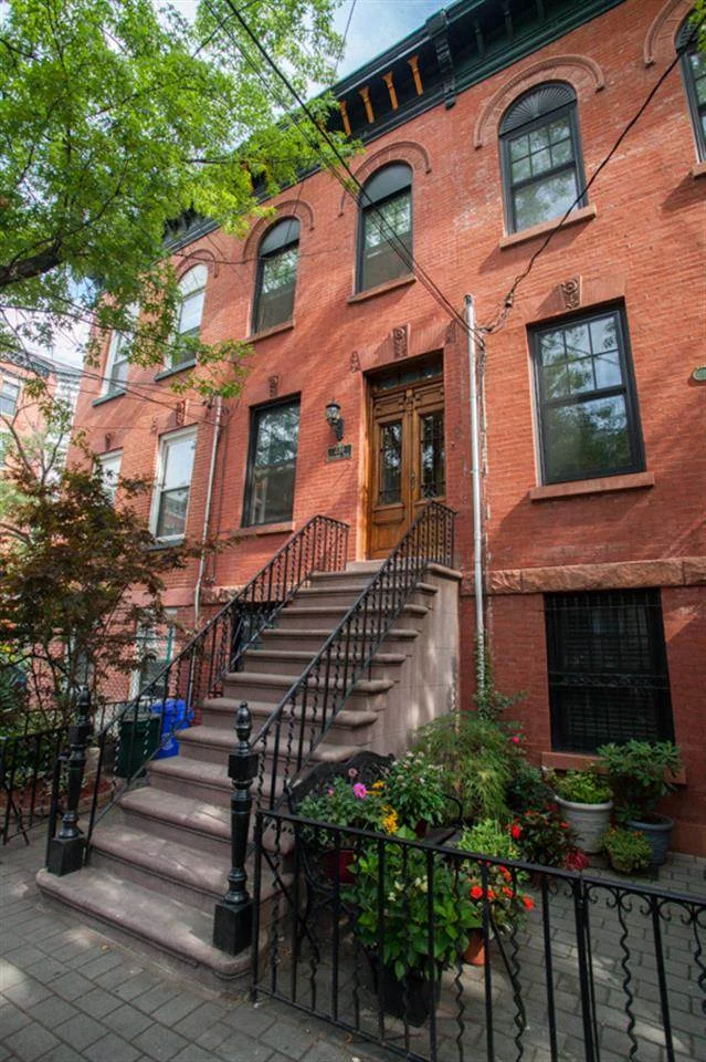 An elegant brick row house w/ desirable uptown address, picturesque tree-lined block, steps to NYC ferry & Hoboken's best restaurants & shops. The perfect meld of period details & modern conveniences. Central Air, gas fireplace, skylights, hardwood floors. Parlor level, sun-filled custom kitchen leading to a deck large enough for alfresco dining w/ lush landscaped garden below. Use as 2 family w/ 2 bed, 1 bath owners duplex & spacious 1 bed income suite or easily convert to the perfect 1 family home.