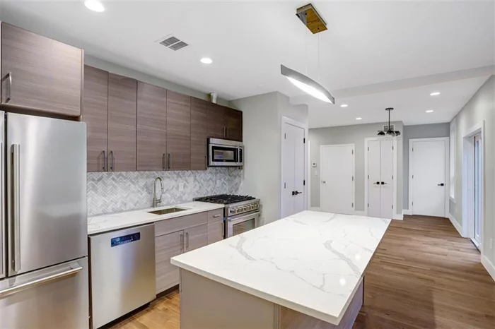 This gem is located in the Heart of Bergen Lafayette! This property is a unique 2 family home that consists of 2 brand new and ultra modern, state of the art units. Unit #1 is a 2 bedroom 1 bathroom, with an open lay out kitchen, stainless steel appliances, C/a and heat, beautiful hardwood floors and washer and dryer. This unit includes a garage, a driveway and a private back yard. Unit #2 is a Duplex (2 floors of living space). This unit boasts a living room, an open lay out kitchen, 2 bedrooms 1 bathroom plus an office space on the 1st level; Second level, has another living room, 2 more bedrooms and one more full bathroom. Gourmet kitchens with stainless steel built in microwaves, stoves, refrigerators, dish washers, spa like bathrooms, gleaming floors and ample bedrooms and closets, make this high end, brand new house, the perfect home!