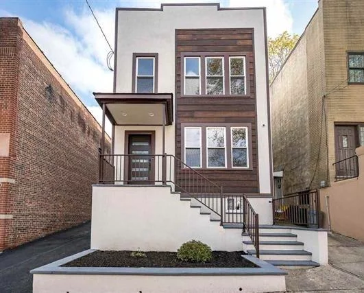 Don't miss this opportunity to own this amazing 2 family home in Jersey City Heights. This renovated home features 5 bedrooms, 3 bathrooms, 3 bonus rooms in the basement, and central AC. making it a perfect investment! The modern kitchens feature SS appliances, custom cabinets and quartz counters. The driveway can easily fit 3-4 cars, leading to the garage that offers parking for 2 cars and storage space. Only unit 1 and basement can be seen. Unit 2 lease up end of Dec.