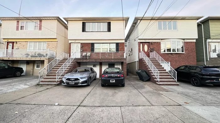 Great opportunity for a 2-family home in a desirable Bayonne neighborhood! Built in 1970, this house features 2 units. Unit 1 is a duplex with a total of 3 bedrooms and 1 bathroom on the first floor, plus an extra 2 rooms and a full bath on the ground level. Unit 2 offers 3 bedrooms, a living room, dining room, kitchen and bathroom. The property includes parking for 3+ cars and 2 attached garages. The property also features a very nice backyard, perfect for enjoying your time and having your own private place of entertainment. Situated in a nice, quiet neighborhood, it's conveniently located just minutes away from the 8th St. Light Rail station and all public transportation. It's also very close to schools, shopping areas, places of worship, and parks. Call for more information
