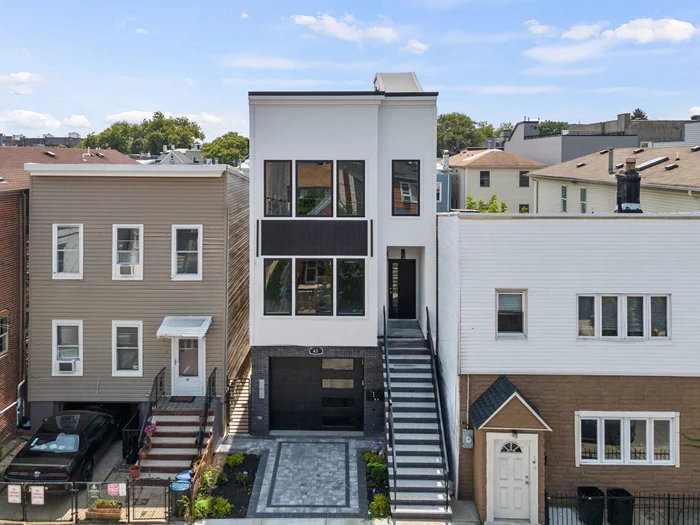 OH this Sat 09/28 @ 2:30-4:30pm and Sun 09/29 @ 3:30-5:30pm! A striking opportunity to own this luxurious 2-Family propertyan impressive ground-up brand new construction in Jersey City Heights! Live in one unit and AirBnb the other unit for a MASSIVE INCOME! or rent out both units for a huge monthly rental. Total of 6br & 4.5ba. Both units feature a spacious living room with an elegant geometric accent wall, large windows that flood the space with natural light, and hardwood flooring throughout the entire home. Modern kitchen with sleek white cabinetry, beautiful calcutta quartz countertops, minimalist backsplash, kitchen island and state-of-the-art stainless steel appliances, including Wine Fridge! Bedrooms have great size windows for bright space and ample closet space. Primary bedrooms feature warm wooden accents, an elegant en suite bathroom with glass-enclosed shower, generous sized walk-in closet and direct access to your own private balcony for a quick sunbath or airy relaxing escape. Unit 1 has an exclusive access to the backyard to accommodate guests or workout spots and Unit 2 has its own private full size rooftop deck for city skyline views--perfect spot for night gatherings! Enjoy the vibrant community and nearby amenities, including Washington Park for leisurely moments. Shops, bars and restaurants are within easy reach, perfect for socializing and dining. Schools are conveniently close, and seamless transportation to NYC awaitsyou're just minutes away from bus stops and train stations. Don't miss out on this exceptional chance to invest and own a remarkable property! *virtually staged photos **also offered as separate units