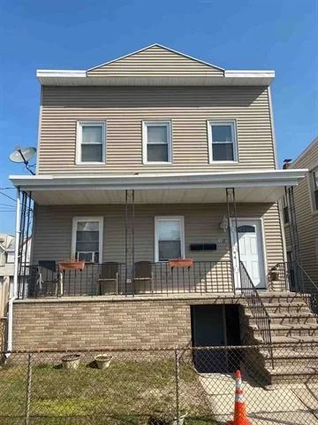 Two family with front porch just steps from the Light Rail station on 1&9. 2 nicely sized two bedroom apts, plus a full finished basement w/walk out. Large back yard.  10 mins to Lincoln tunnel. 2 blocks from light rail station. Low taxes!!!