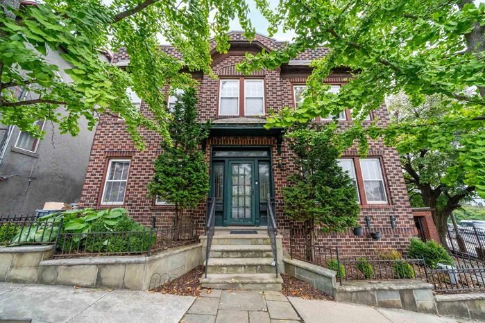 This gorgeous two family with twin garages and forever-protected city views crowns a quiet Weehawken cul-de-sac a stone's throw from easy transport into NYC. The two-tone, Flemish-bond brick facade and brand new roof with solar panels protects the home. The dual-zone central heat and air systems ensure your comfort within. Main floor offers updated chef's kitchen with integrated refrigerator, farmhouse sink, stainless steel range with pot-filler, handsome marble countertop and backsplash. Entertain with ease in your oversized great room featuring diagonal basket hardwood floors with inlay detail, dedicated dining area and three-season room flooded with light from it's walls of windows. Two bedrooms with great storage and in-unit laundry complete the main floor sharing an updated full bathroom with claw-foot tub, custom herringbone tile floor and frameless glass shower enclosure. The home's garden level offers a summer kitchen, an additional living space, another bedroom and a full bathroom. All this, plus a full laundry room as well as access to your oasis, a three-level terraced garden with bluestone retaining walls, story-book trellis and mature perennial plantings. Top floor of the home offers still more living space with improved city views, a recently updated kitchen with every amenity and a full bathroom in addition to two bedrooms and in-unit laundry. Home comes with approved plans to add an additional 2000sf across three floors plus a south-facing roof-terrace with unobstructed views of the iconic NYC skyline.